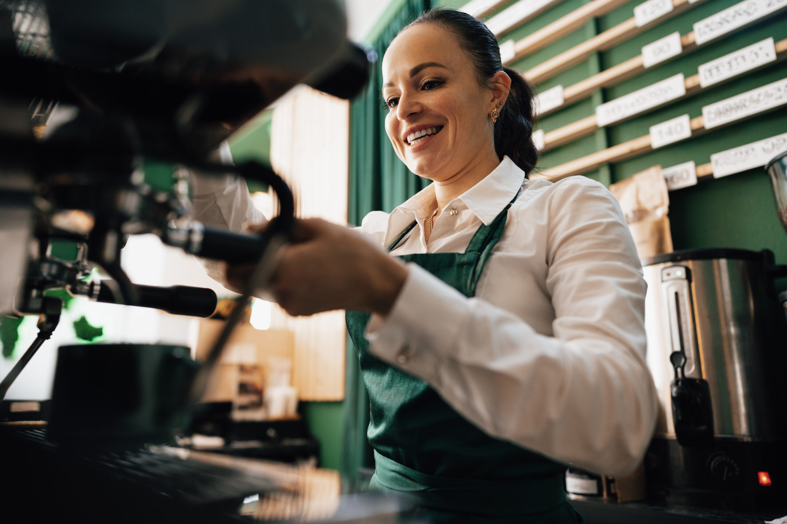 Home caucasian female barista at work making coffee